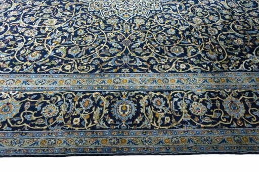 Corner detail of 2000s Kashan rug showing border pattern and Wool pile