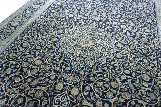Backside of handmade 2000s Kashan rug showing knot structure and weave density