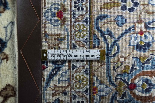 Backside of handmade 2000s Kashan rug showing knot structure and weave density