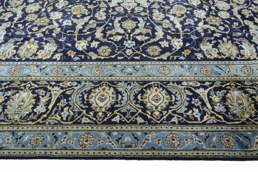 Corner detail of 2000s Kashan rug showing border pattern and Wool pile