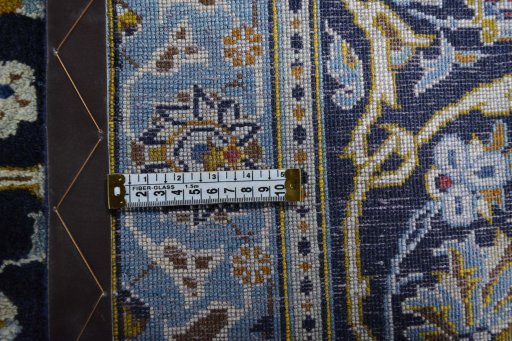 Backside of handmade 2000s Kashan rug showing knot structure and weave density