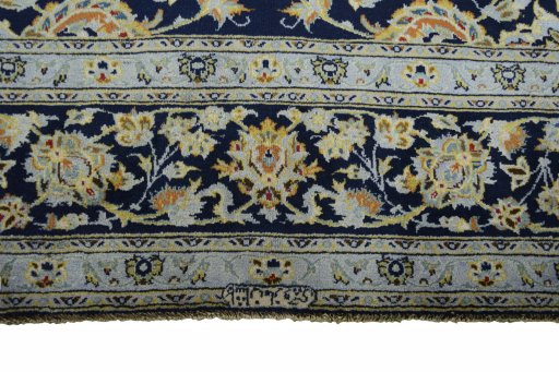 Corner detail of 2000s Kashan rug showing border pattern and Wool pile