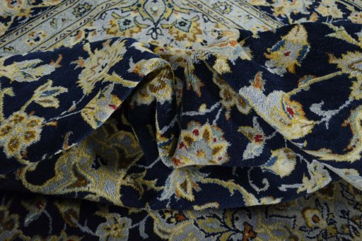 Backside of handmade 2000s Kashan rug showing knot structure and weave density
