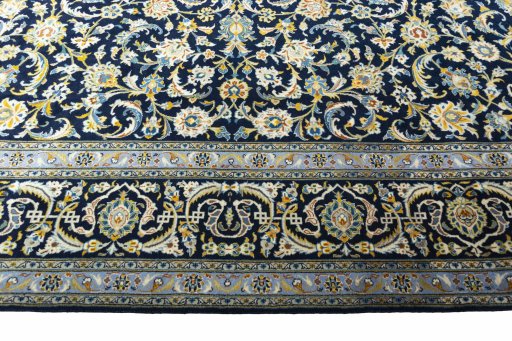 Corner detail of 2000s Kashan rug showing border pattern and Wool pile