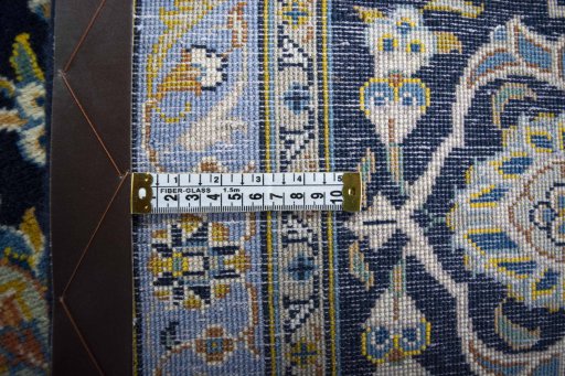 Backside of handmade 2000s Kashan rug showing knot structure and weave density