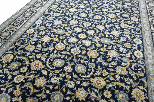 Backside of handmade 2000s Kashan rug showing knot structure and weave density