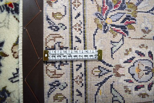 Backside of handmade 2000s Kashan rug showing knot structure and weave density