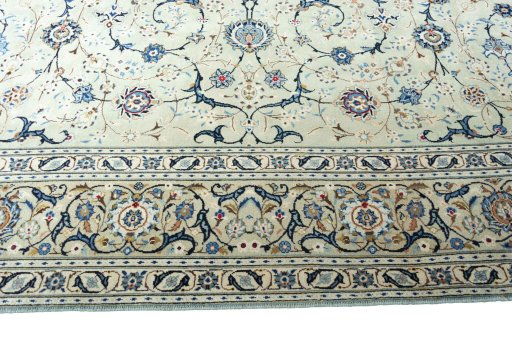 Corner detail of 2000s Kashan rug showing border pattern and Wool pile