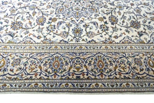 Corner detail of 2000s Kashan rug showing border pattern and Wool pile