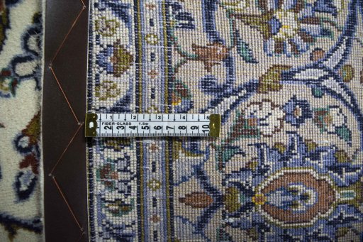 Backside of handmade 2000s Kashan rug showing knot structure and weave density
