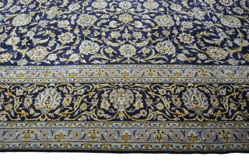 Corner detail of 2000s Kashan rug showing border pattern and Wool pile