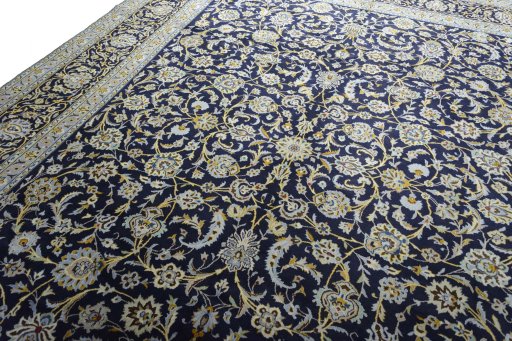 Backside of handmade 2000s Kashan rug showing knot structure and weave density