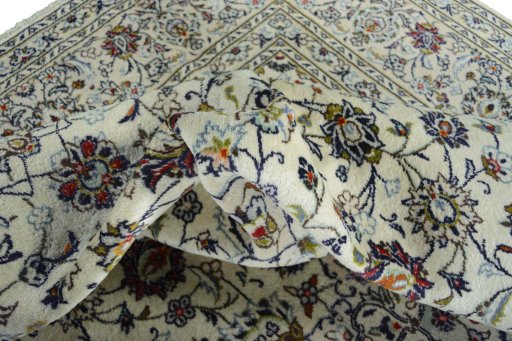 Backside of handmade 2000s Kashan rug showing knot structure and weave density