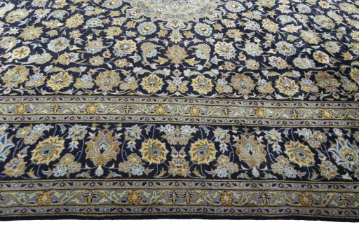 Corner detail of 2000s Kashan rug showing border pattern and Wool pile