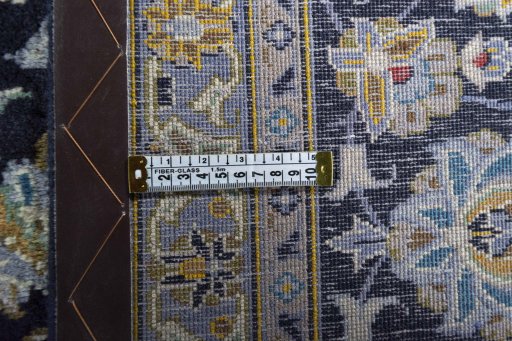 Backside of handmade 2000s Kashan rug showing knot structure and weave density