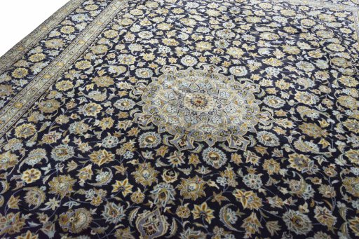 Backside of handmade 2000s Kashan rug showing knot structure and weave density
