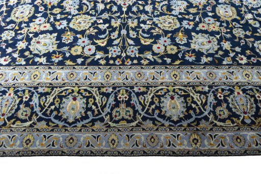 Corner detail of 2000s Kashan rug showing border pattern and Wool pile