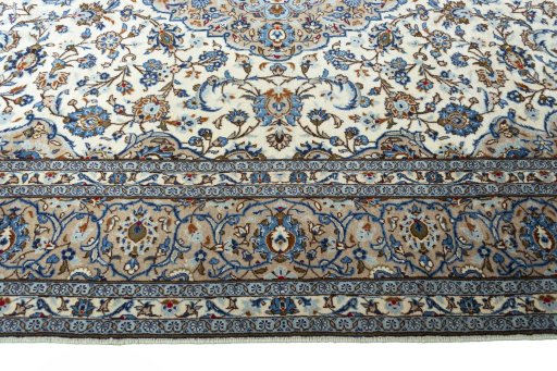 Corner detail of 2000s Kashan rug showing border pattern and Wool pile