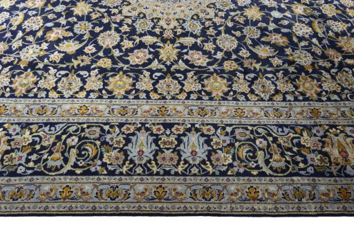 Corner detail of 2000s Kashan rug showing border pattern and Wool pile