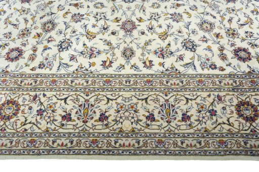 Corner detail of 2000s Kashan rug showing border pattern and Wool pile