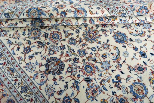 Backside of handmade 2000s Kashan rug showing knot structure and weave density