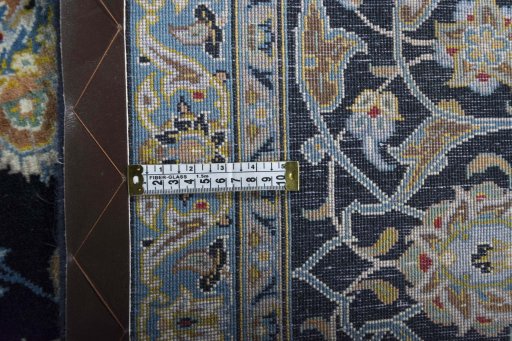 Backside of handmade 2000s Kashan rug showing knot structure and weave density
