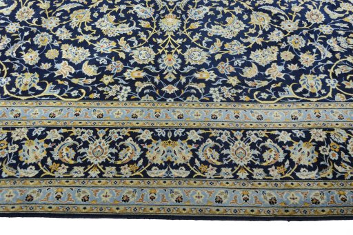 Corner detail of 2000s Kashan rug showing border pattern and Wool pile