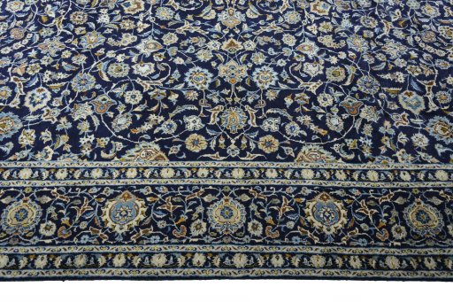 Corner detail of 2000s Kashan rug showing border pattern and Wool pile
