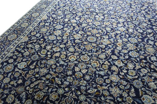Backside of handmade 2000s Kashan rug showing knot structure and weave density