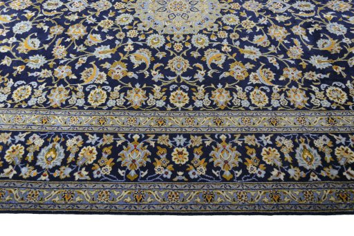 Corner detail of 2000s Kashan rug showing border pattern and Wool pile