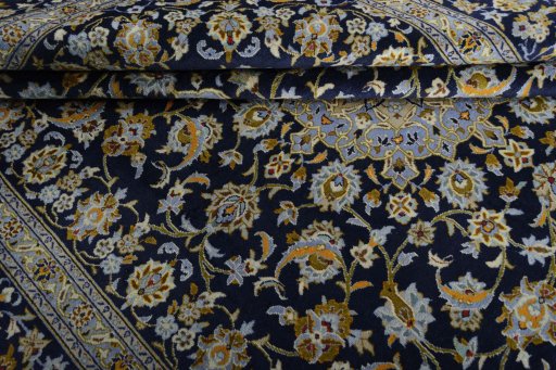 Backside of handmade 2000s Kashan rug showing knot structure and weave density