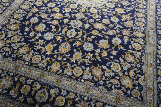 Close-up detail of 2000s Kashan rug from Iran / Persia showing Wool weave