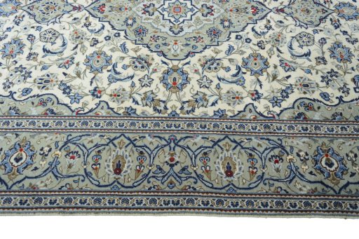 Corner detail of 2000s Kashan rug showing border pattern and Wool pile
