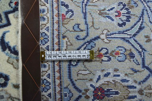 Backside of handmade 2000s Kashan rug showing knot structure and weave density
