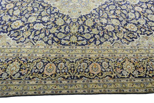 Corner detail of 2000s Kashan rug showing border pattern and Wool pile