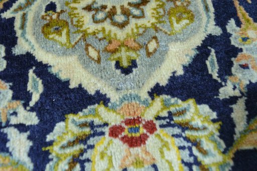 Close-up detail of 2000s Kashan rug from Iran / Persia showing Wool weave