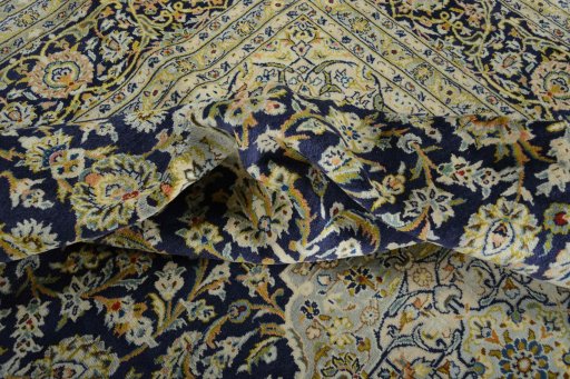 Backside of handmade 2000s Kashan rug showing knot structure and weave density