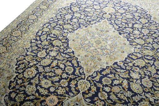 Backside of handmade 2000s Kashan rug showing knot structure and weave density