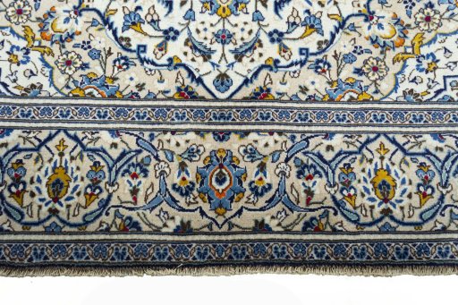 Corner detail of 2000s Kashan rug showing border pattern and Wool pile