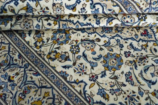 Backside of handmade 2000s Kashan rug showing knot structure and weave density