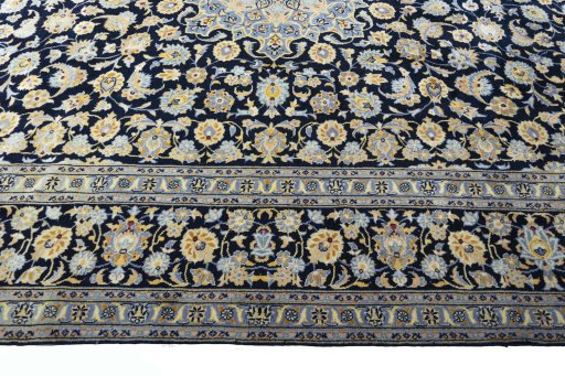 Corner detail of 2000s Kashan rug showing border pattern and Wool pile