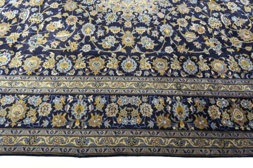 Corner detail of 2000s Kashan rug showing border pattern and Wool pile