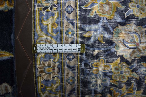 Backside of handmade 2000s Kashan rug showing knot structure and weave density