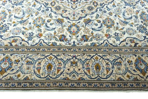 Corner detail of 2000s Kashan rug showing border pattern and Wool pile