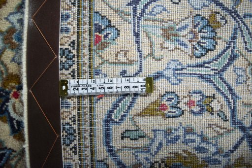 Backside of handmade 2000s Kashan rug showing knot structure and weave density