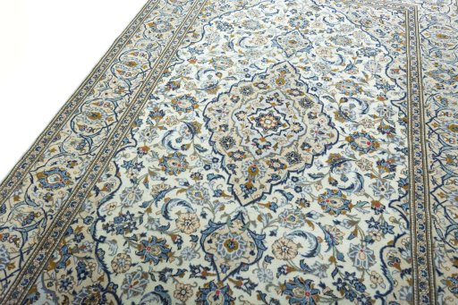 Backside of handmade 2000s Kashan rug showing knot structure and weave density