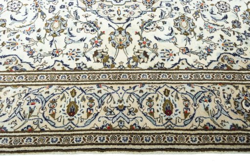 Corner detail of 2000s Kashan rug showing border pattern and Wool pile