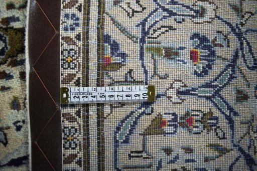 Backside of handmade 2000s Kashan rug showing knot structure and weave density