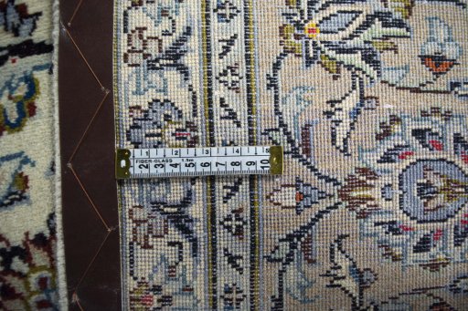 Backside of handmade 2000s Kashan rug showing knot structure and weave density
