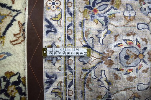Backside of handmade 2000s Kashan rug showing knot structure and weave density